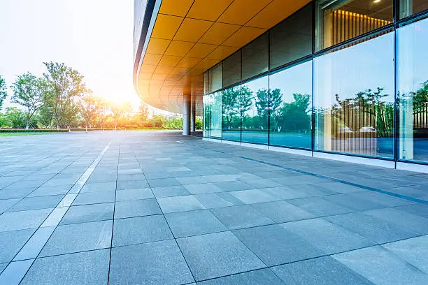 Photo of empty brick road nearby office building