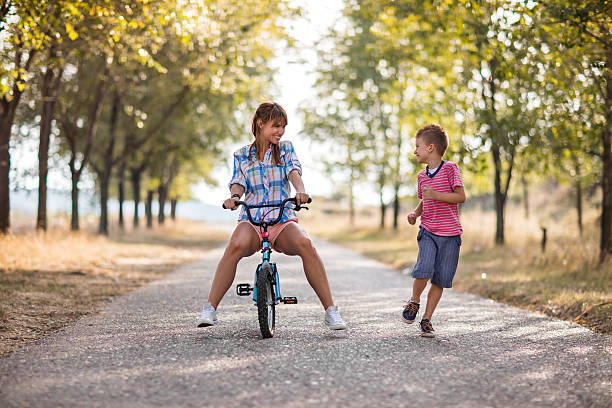 istock Playful mother and her son having fun in nature. 612627328