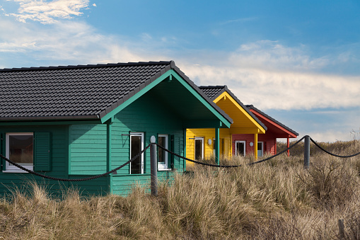 Helgoland city - colorful wooden tiny houses on the island Dune near island Helgoland against blue sky