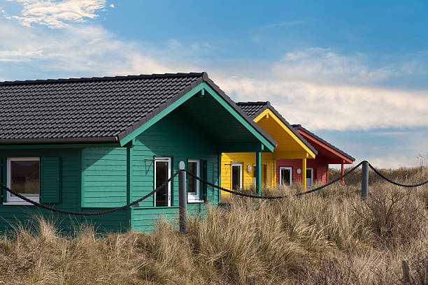colorful wooden tiny houses on the island Helgoland city - colorful wooden tiny houses on the island Dune near island Helgoland against blue sky tiny house photos stock pictures, royalty-free photos & images