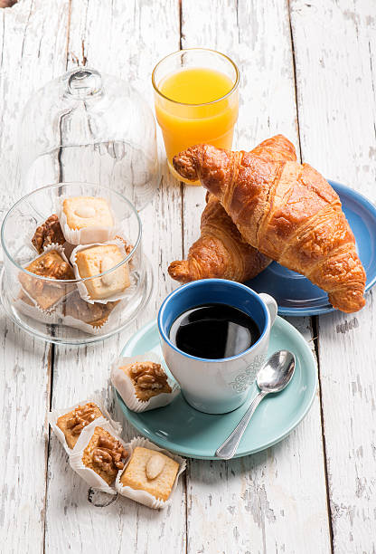 istock breakfast with coffee orange juice brioche and cookie 612628546