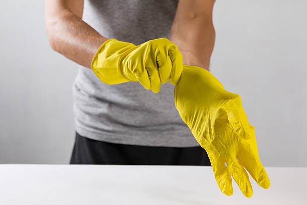 istock Young man wearing yellow rubber gloves. Ready to cleaning 612629290