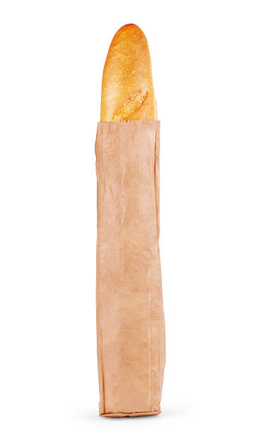 istock Fresh Baguette in a paper bag, over the white background. 612630672
