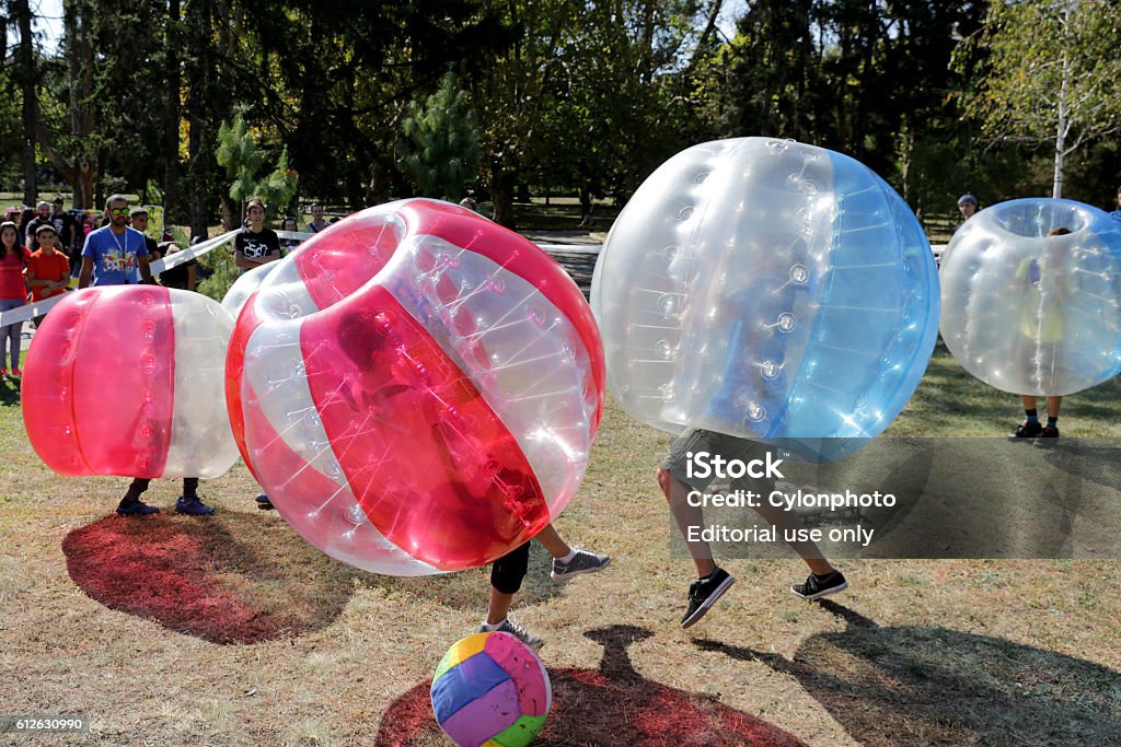 Bubble football game Sofia, Bulgaria - September 24, 2016: Boys are playing bubble football game in the park. Bubble Stock Photo