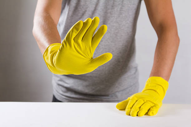 istock Young man in a yellow rubber gloves refuses to do 612632114
