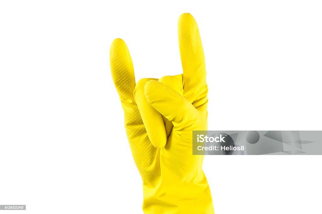 Woman's hand in yellow rubber gloves shows 'Horns Up Woman's hand in yellow rubber gloves shows 'Horns Up' sighn. Fun house keaping concept Adult Stock Photo