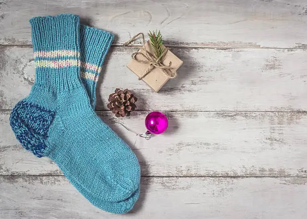Background socks, fir-cone, Christmas gift on wooden background