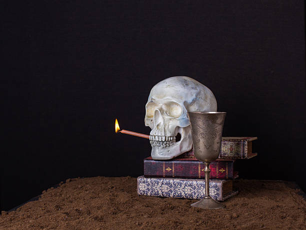 istock The skull is holding in his mouth a burning candle 612632720
