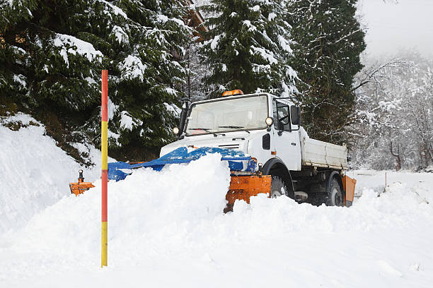 istock Snow plough making its way through the snowy country road 612633380