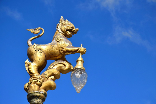 Street lamp with lion sculpture.