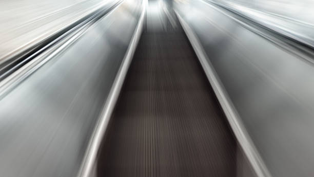 istock blurred motion of airport moving walkway 612634322
