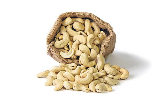 istock Cashew nuts in burlap sack on white background, Food. 612634334