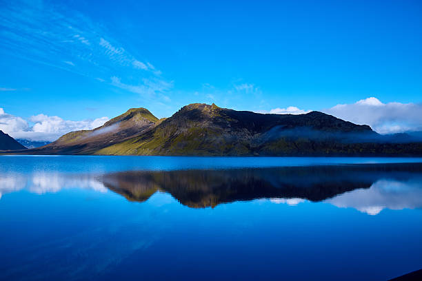 istock Lake coast with mountain reflection, Iceland 612634920
