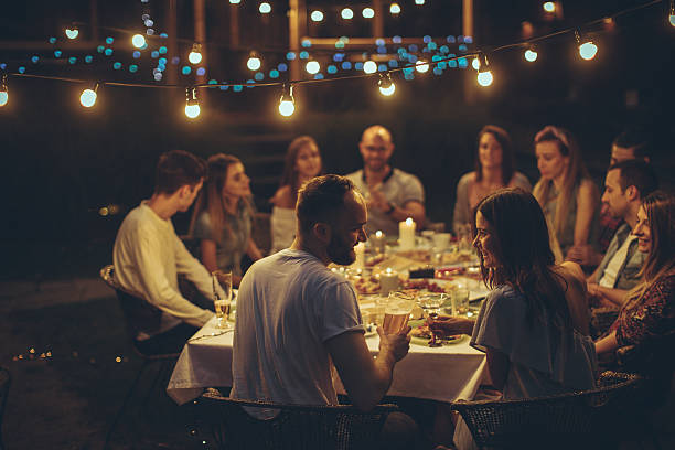 istock Friends gathered over dinner 612635400