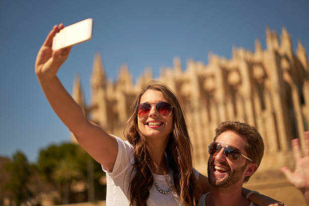 istock couple taking selfie in front of cathedral 612635642