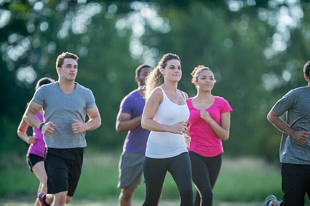istock Friends Running Through the Park 612636628