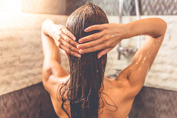 istock Beautiful woman taking shower 612637544