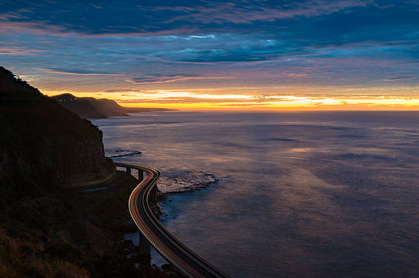istock Sea Cliff Bridge on sunrise with moving traffic 612638632