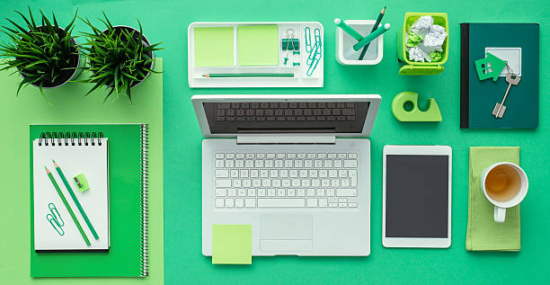 Green creative desktop Green creative and eco-friendly desktop with laptop and office accessories, business and environmental care concept, flat lay office cubicle photos stock pictures, royalty-free photos & images