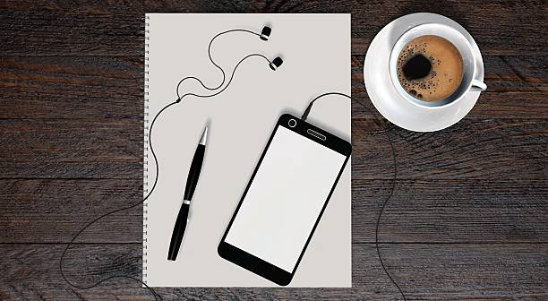 smartphone and earphones with coffee and white paper on table