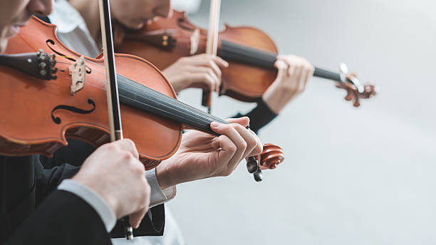 Violin duet performance Two violinists performing together hands close up, classical music concert symphony orchestra photos stock pictures, royalty-free photos & images