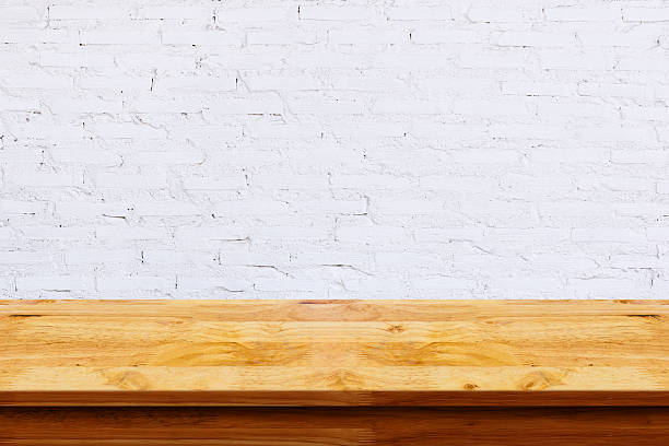 istock Empty top of wooden table with white brick background. 612641790