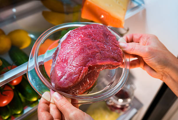 Fresh raw meat on a shelf open refrigerator stock photo