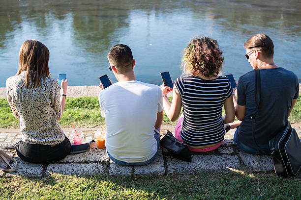 Just chillin' with their smart phones stock photo