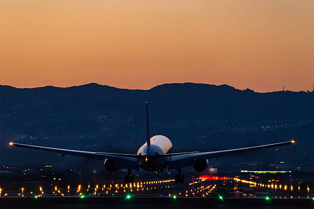 istock Airplane landing at dusk 612646282