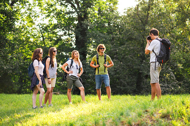 Friendship, travel, vacation, happiness summer and people concept. Group of smiling friends with map traveling