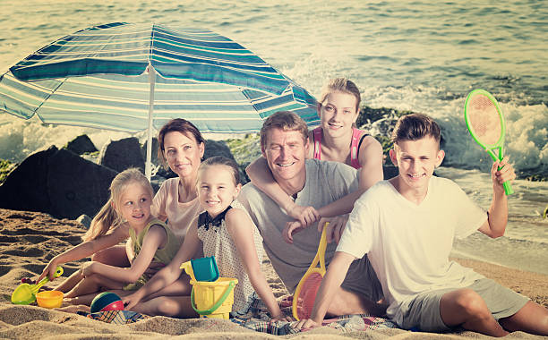large happy family on beach sitting on weekend - family large american culture fun imagens e fotografias de stock