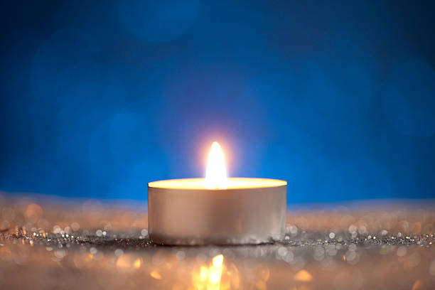 istock Candle on silver glitter with dark blue background 612649162