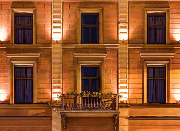 Stylish christmas lights on old building in evening, fairytale decoration. Atmospheric magic time. Christmas festive decor for winter holidays in city street. Merry Christmas!