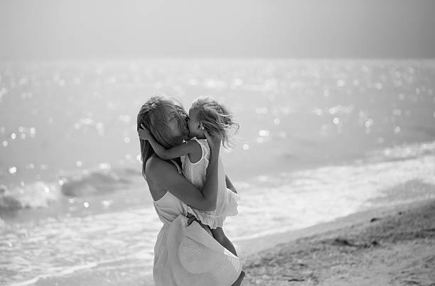 concept of love, motherhood, caring, black and white stock photo