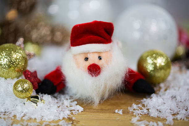 istock Santa Claus with Christmas balls - glittering background 612651366
