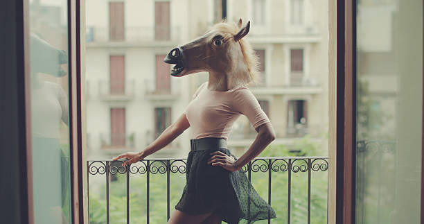 beautiful black woman portrait with horse head - gekke paarden stockfoto's en -beelden