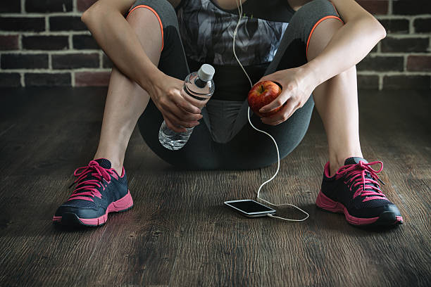 istock take rest listening to music drinking water eating apple 612653500