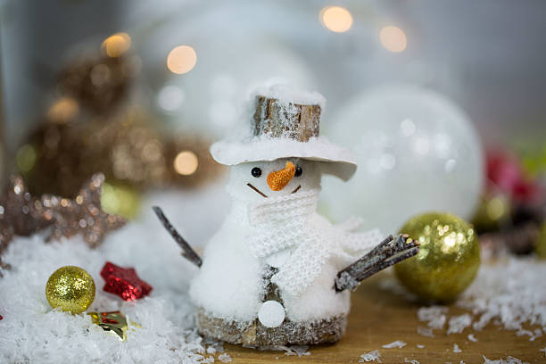 istock Snowman with Christmas baubles - glittery background 612653896
