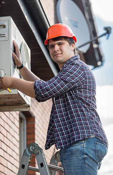 istock Professional electrician repairing air conditioner on outer wall 612653966