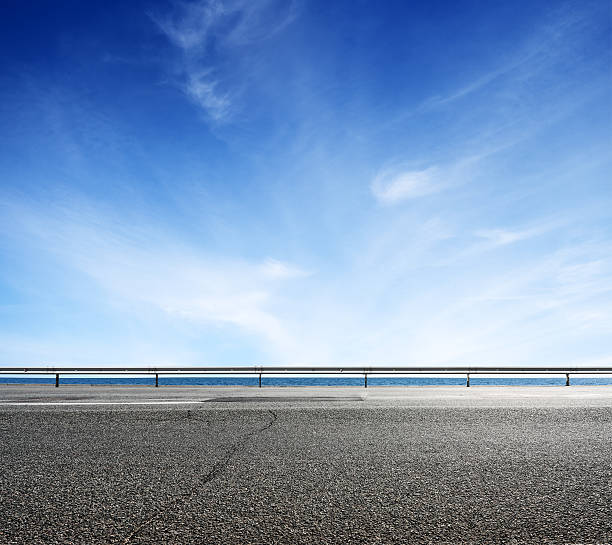 istock Asphalt road and sea coast line 612654128
