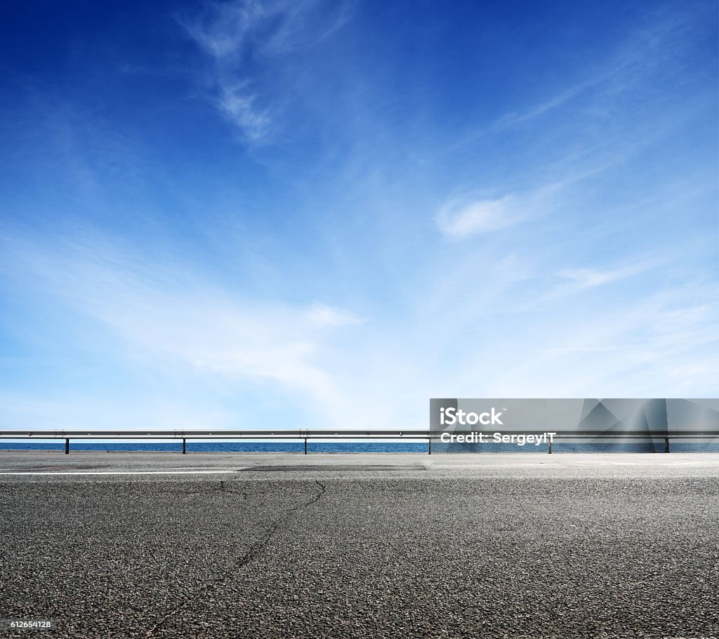 Asphalt road and sea coast line Asphalt road and sea coast line with blue sky on horizon. Landscape in sunny summer day Roadside Stock Photo