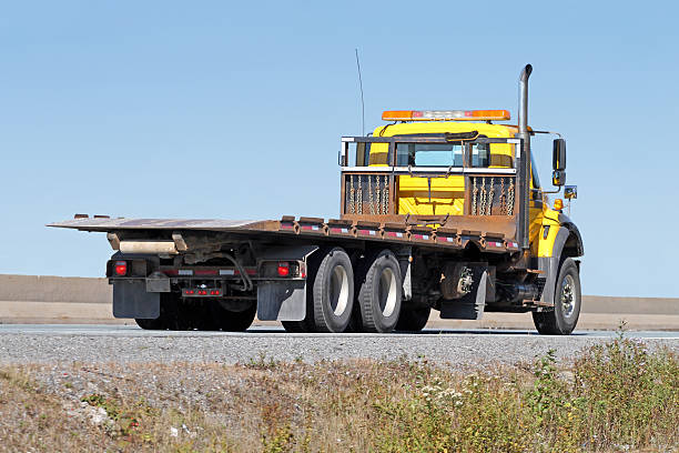 istock Tilt Bed Tow Truck Travelling Interstate Highway, No Load 612654594