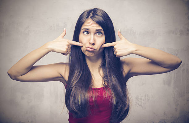 istock Young woman making a funny face 612657414