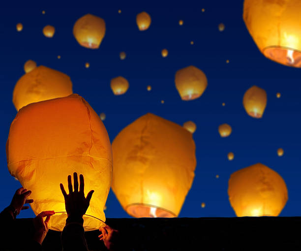 istock bright lantern in human hands on night background 612658164