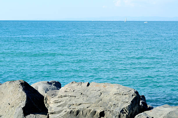 istock Black rocks,blue sky and sea 612658636