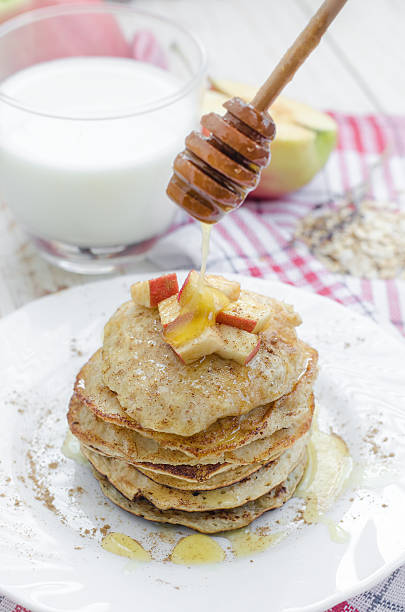 Oatmeal pancakes with apple and honey Oatmeal pancakes with apple and honey. Healthy breakfast. apple cinnamon pancake stock pictures, royalty-free photos & images