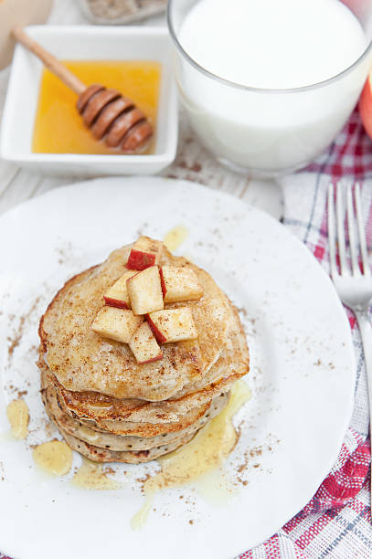 istock Oatmeal pancakes with apple and honey. 612658898