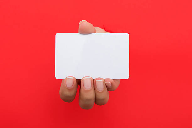 istock Female hand reaching through torn red paper sheet 612659474