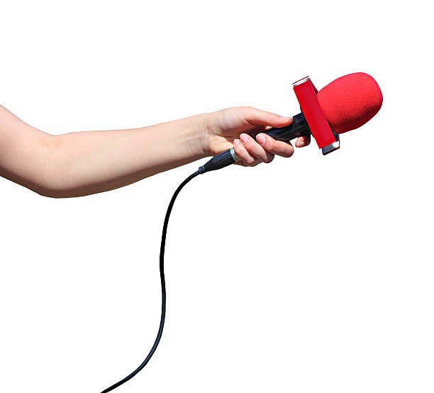 Hand with red microphone isolated Hand with red microphone isolated on white background tv reporter photos stock pictures, royalty-free photos & images