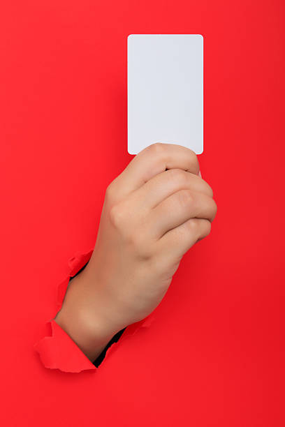 istock Female hand reaching through torn red paper sheet 612661740